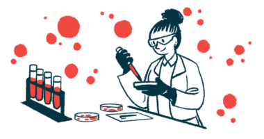 A scientist wearing safety goggles works with petri dishes and vials in a lab.