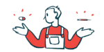 A person balances a pill in one hand and a syringe in the other.