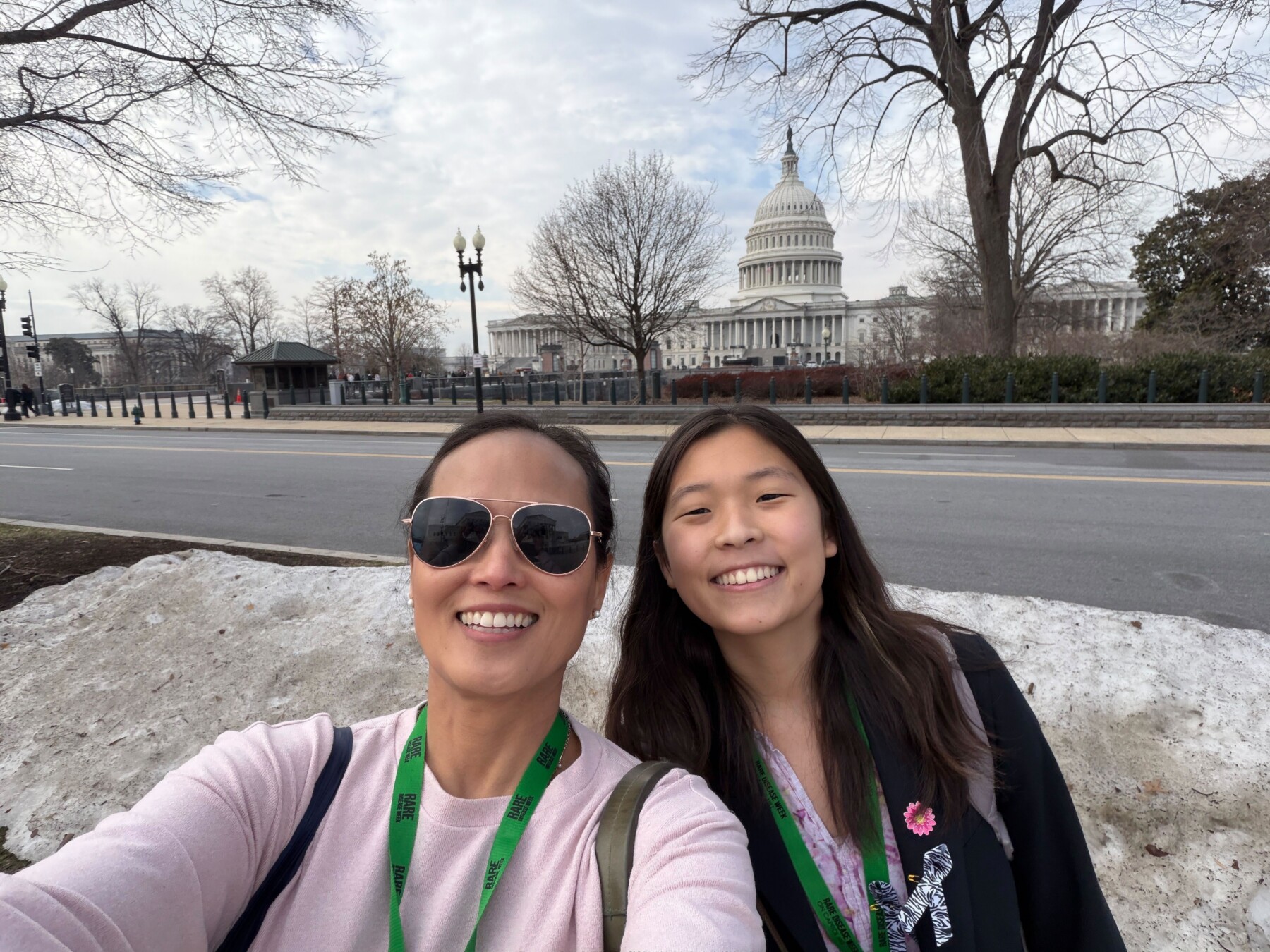 A mother and daughter take a selfie together in Washington, D.C., with the U.S. Capitol in the background.